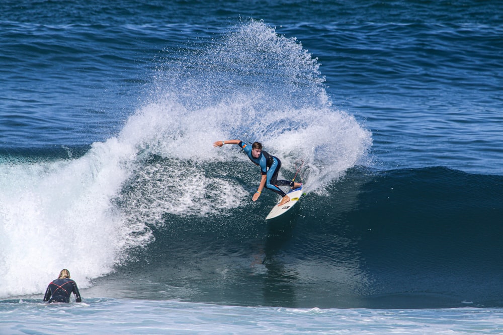 man surfing on sea waves during daytime