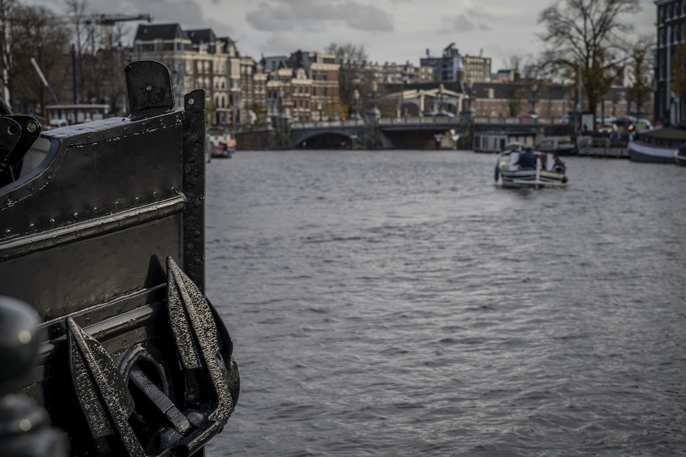 black and white boat on water near city buildings during daytime