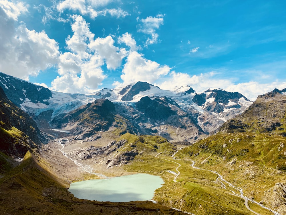 brown and white mountains under blue sky and white clouds during daytime