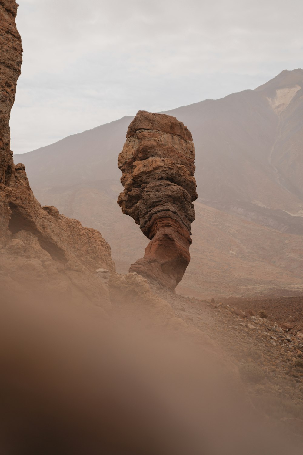 brown rock formation under white sky during daytime