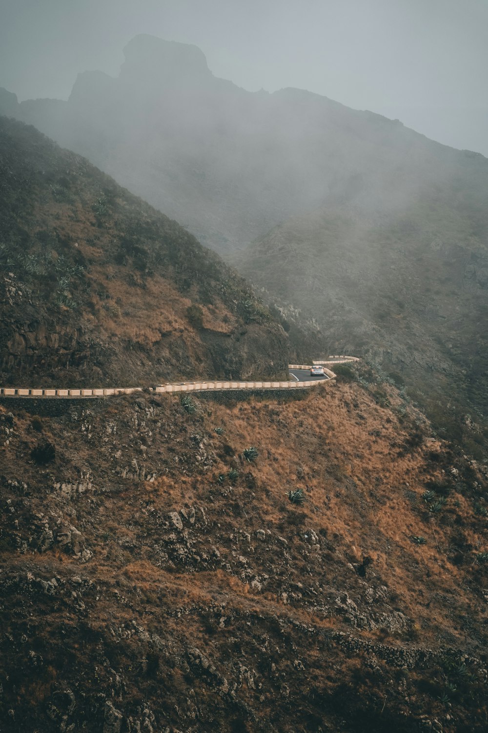 white train on rail on mountain