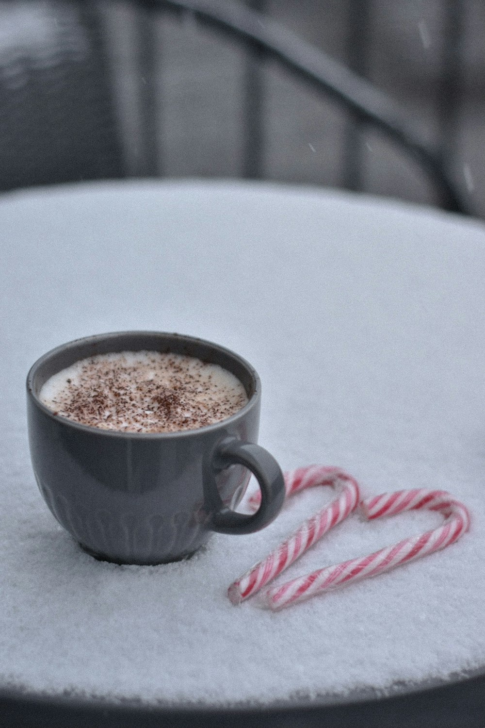 white ceramic mug with brown liquid inside