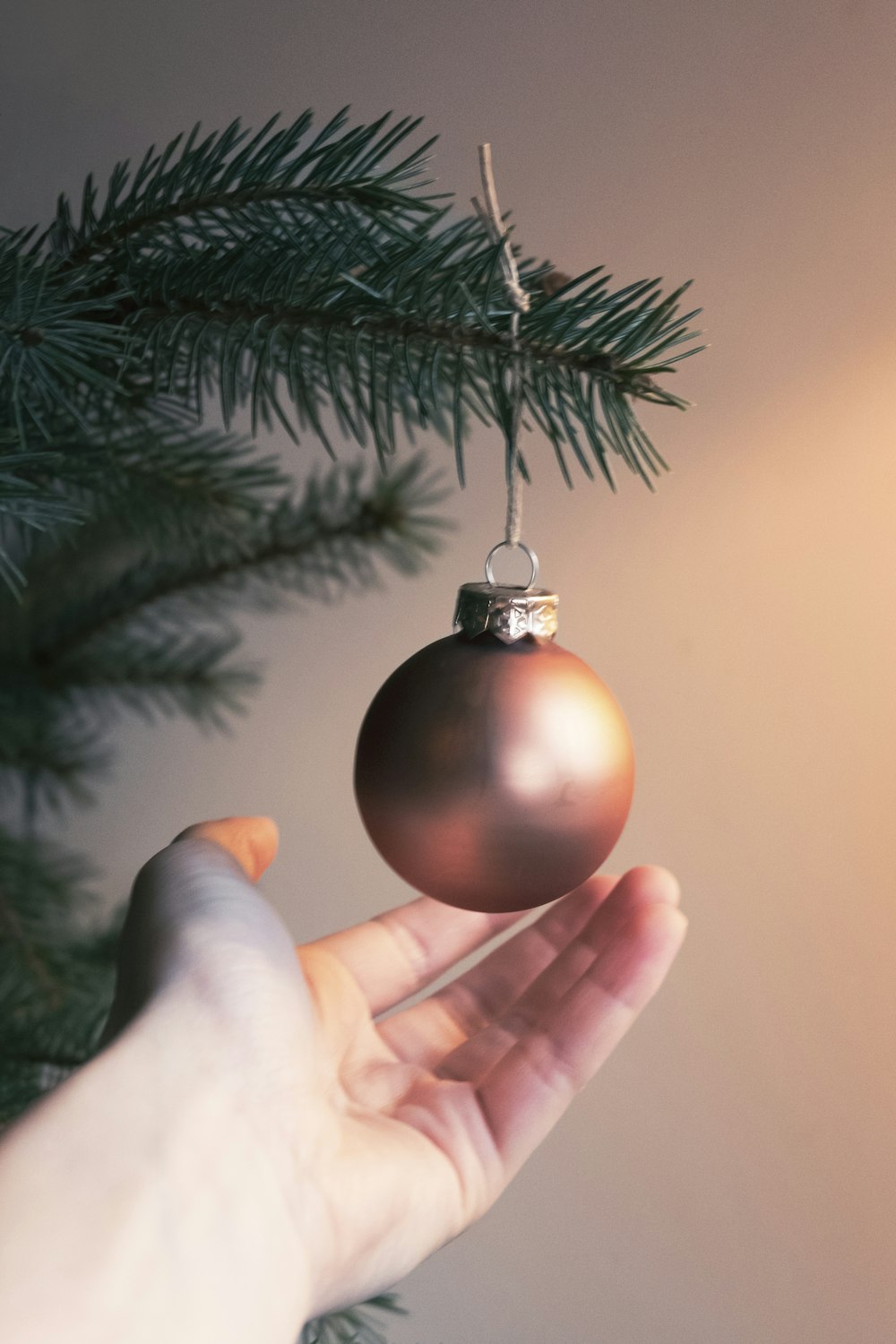 gold bauble on persons hand
