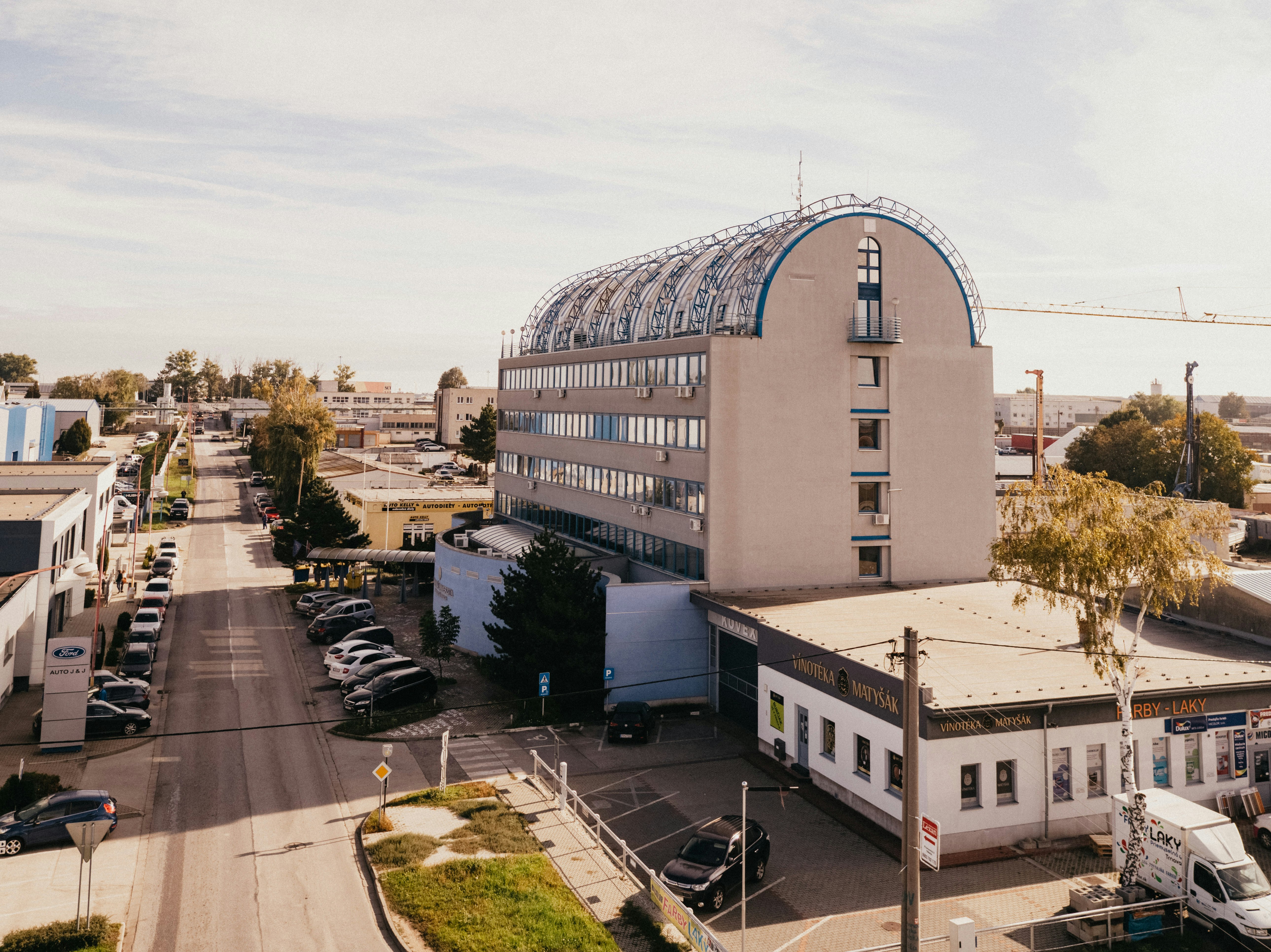 white concrete building near green trees during daytime