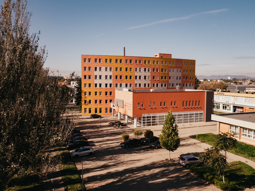 brown concrete building near green trees during daytime