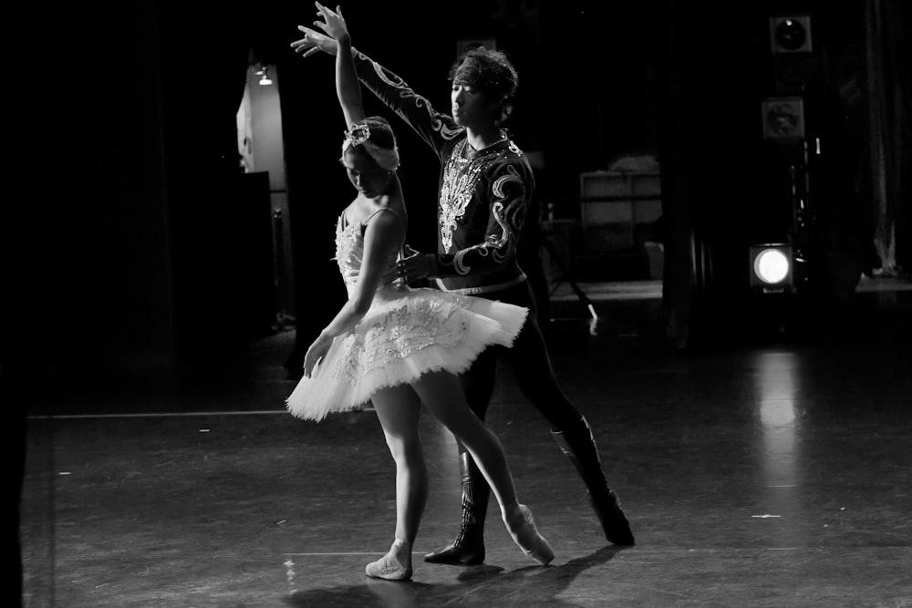 grayscale photo of woman in white dress dancing