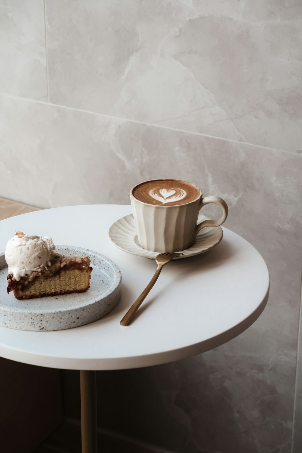 white ceramic mug on white ceramic plate