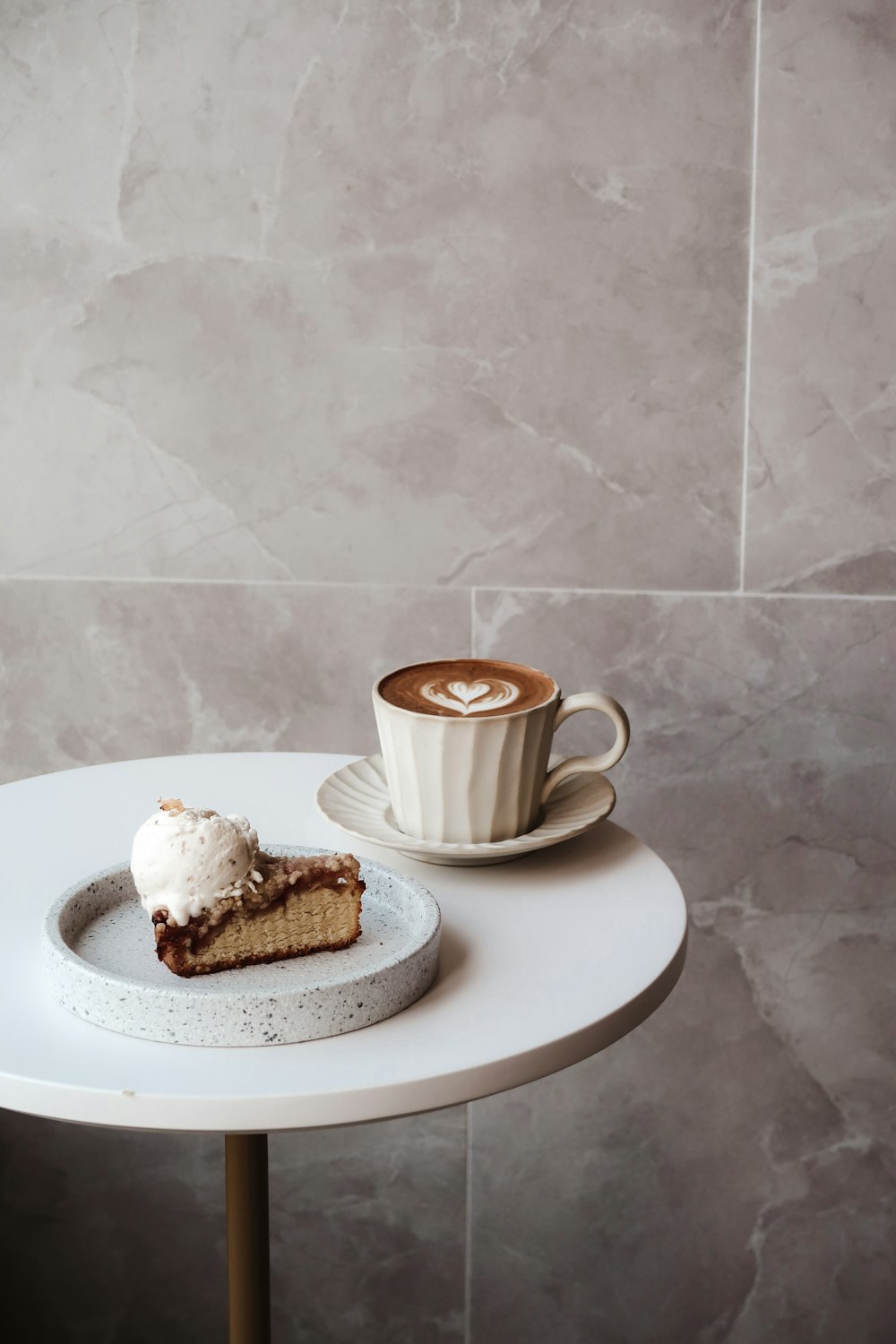 white ceramic mug on white ceramic plate