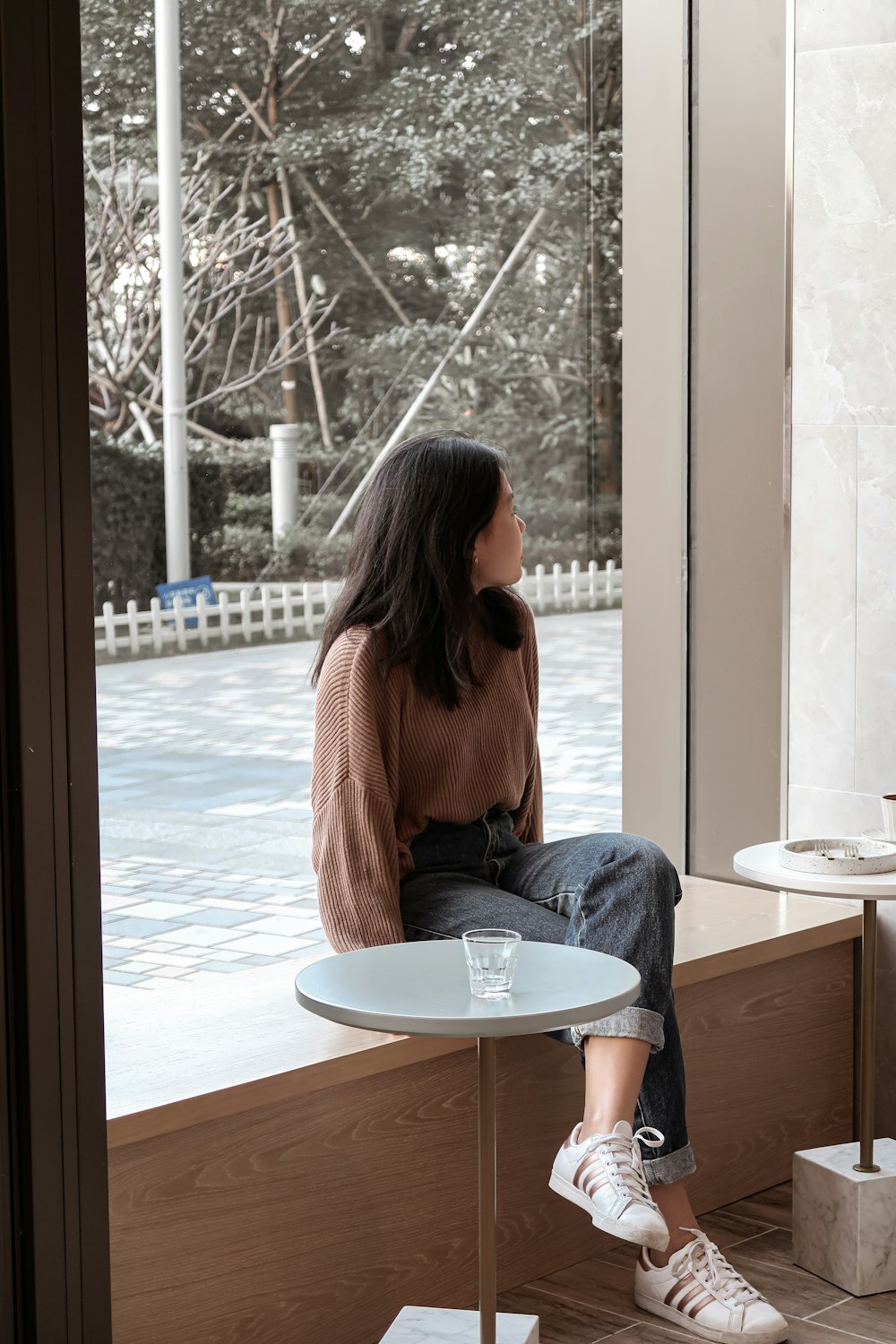 woman in orange long sleeve shirt sitting on chair