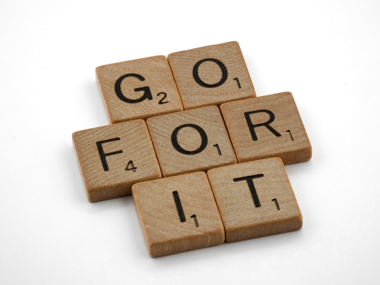Image of a Scrabble pieces arranged to say 'GO FOR IT' 