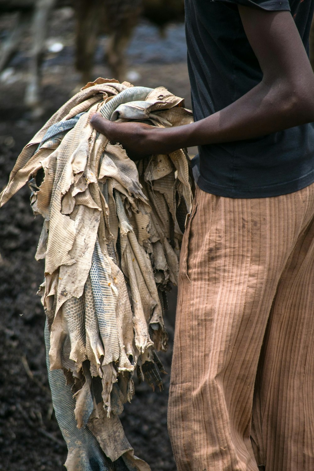 person in black t-shirt holding brown textile