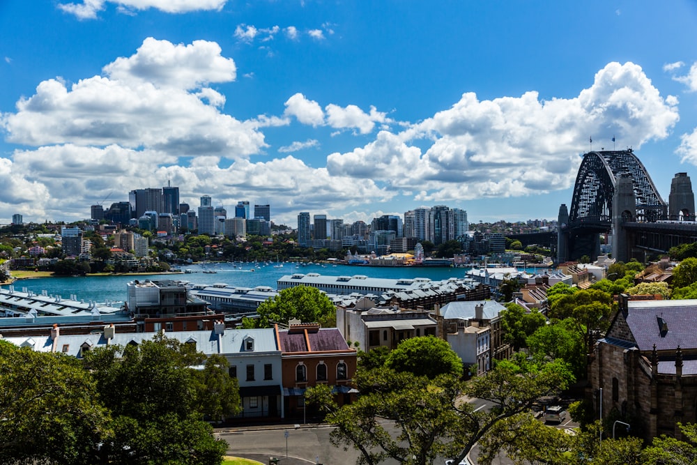 white and brown concrete buildings under white clouds and blue sky during daytime