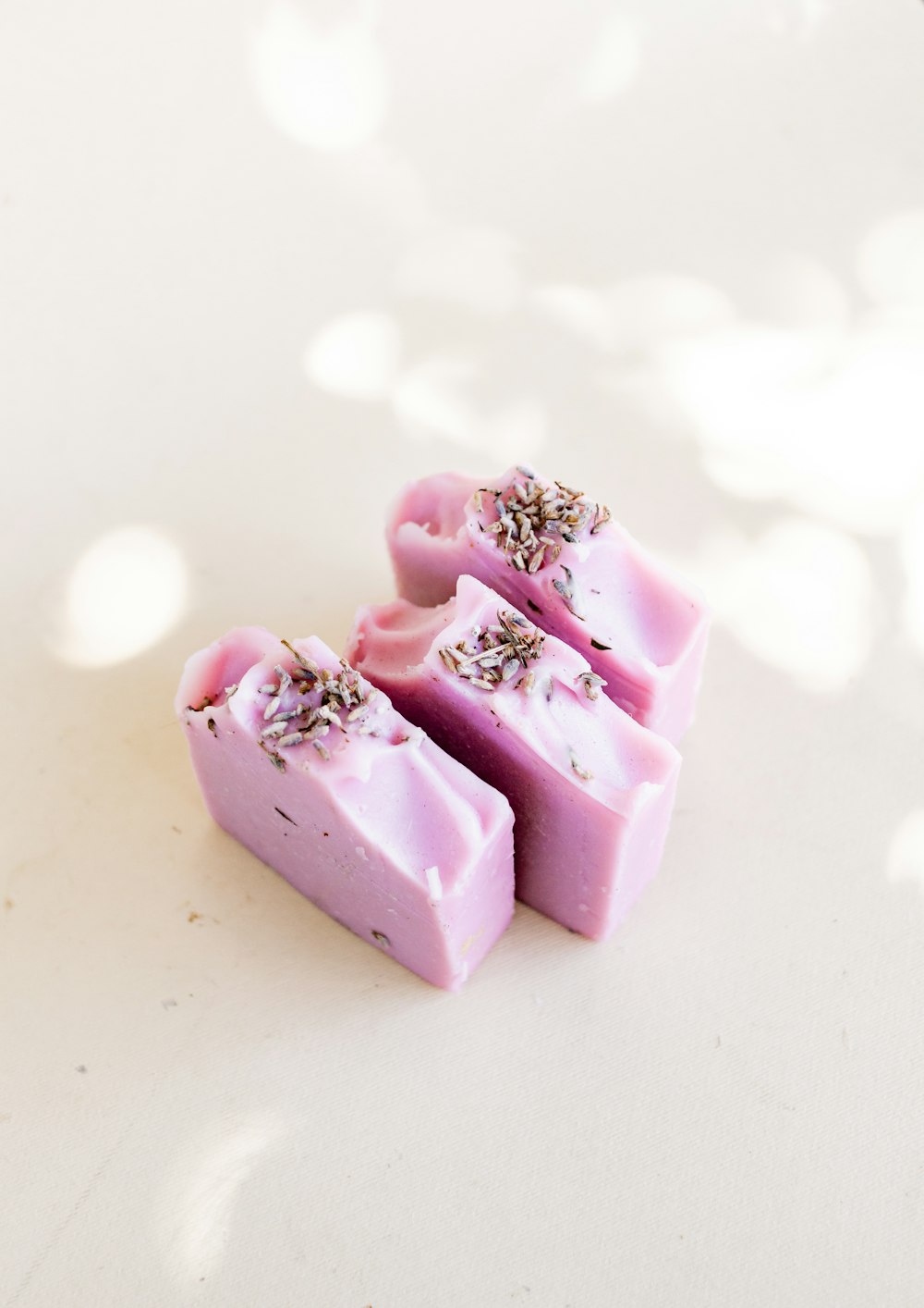 pink heart shaped candy on white surface