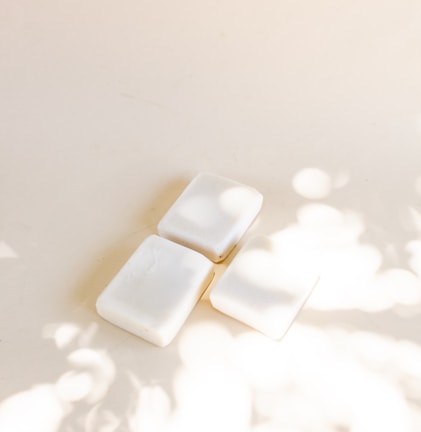 A peaceful scene of soap bars drying on a linen cloth, bathed in gentle natural light.