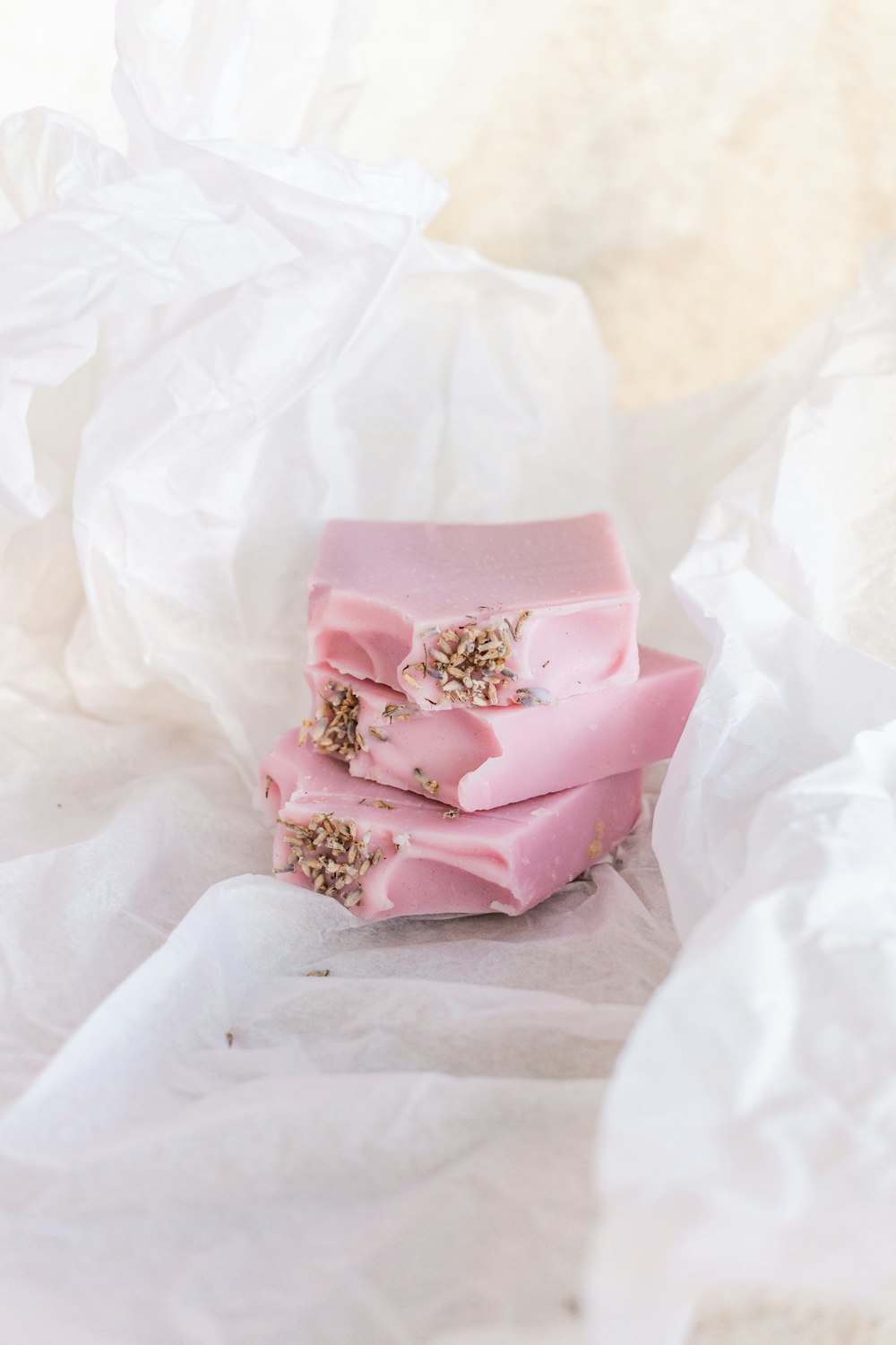 pink and white floral gift box on white textile