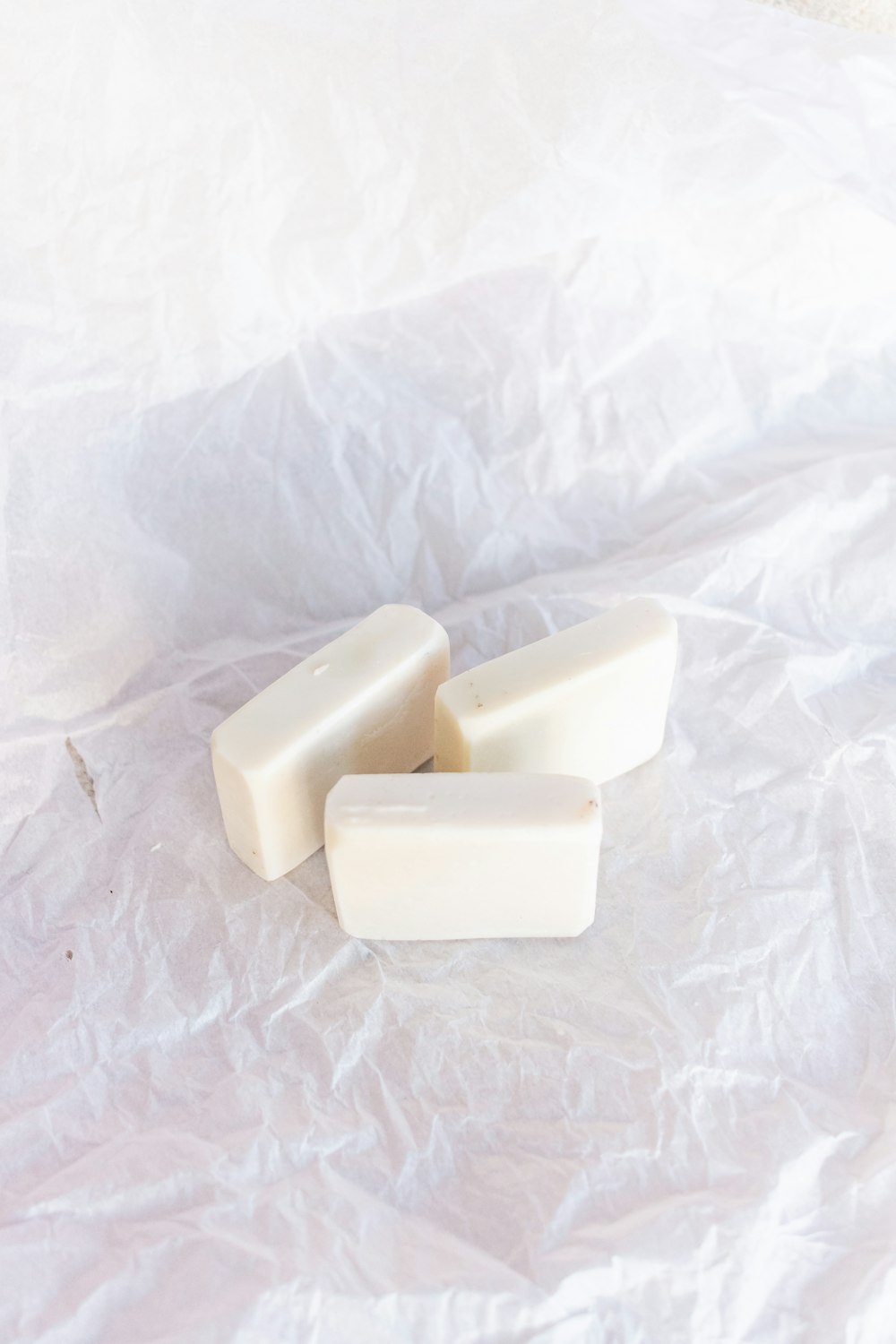 white soap bar on white textile