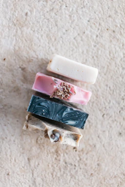 Artisan soap bars stacked neatly with soft lather and natural botanical accents.