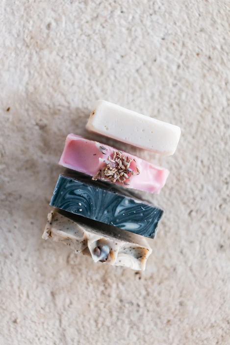 Artisan soap bars stacked neatly with soft lather and natural botanical accents.