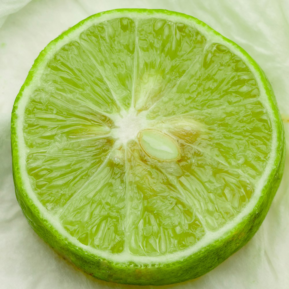 sliced green lime on white textile