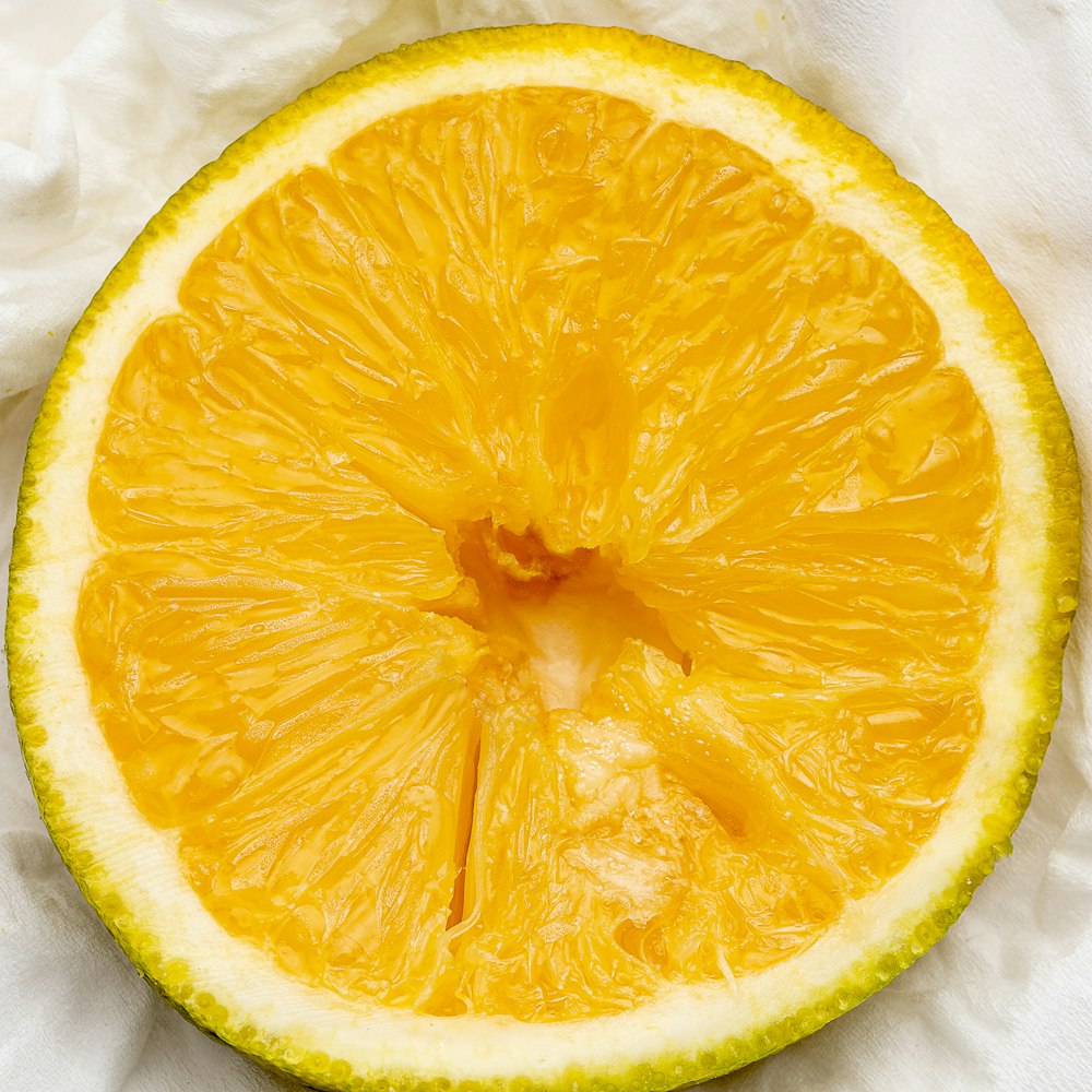 sliced orange fruit on white textile