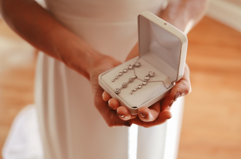 person holding white plastic case