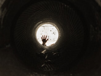 man in black shirt standing on tunnel