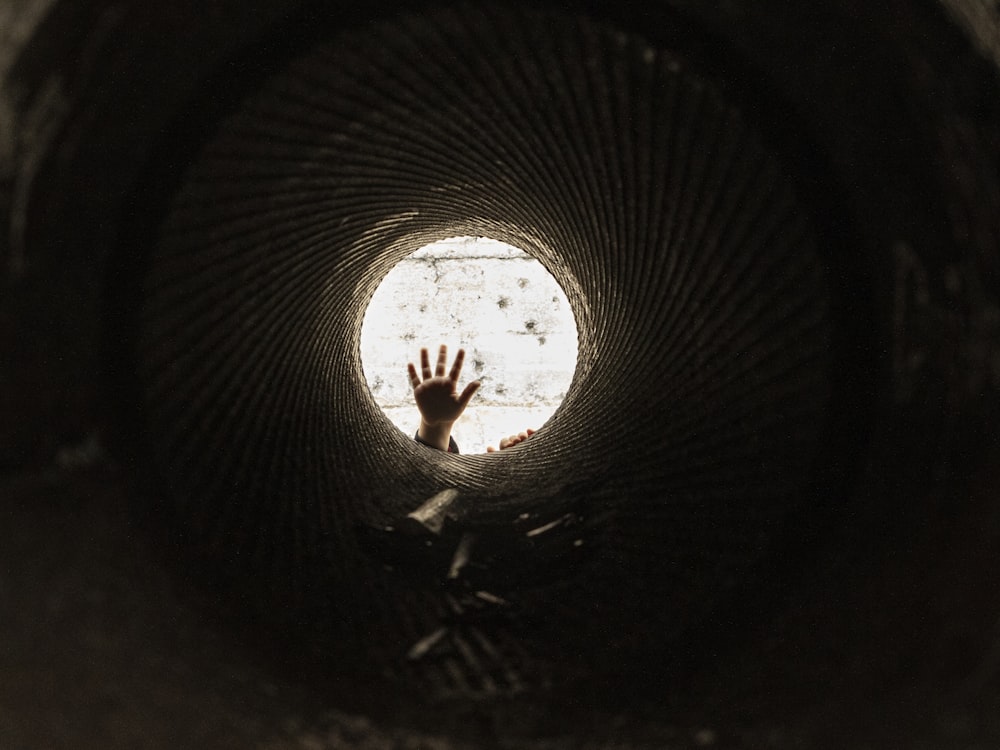 man in black shirt standing on tunnel