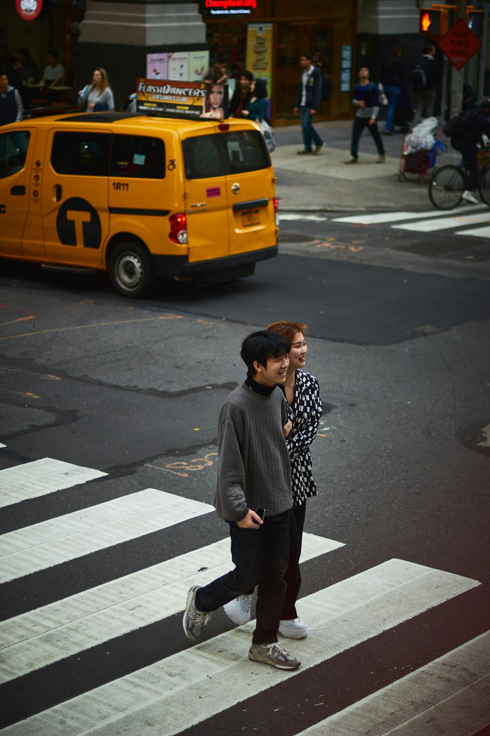 man in black jacket standing on pedestrian lane during daytime