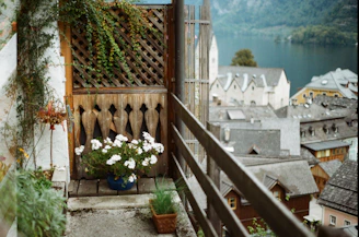 Balcony overlooking Lake Garda with colorful flowers and tranquil water views.