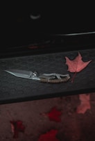 black handled knife on black surface