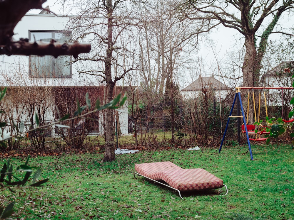 brown and white striped hammock on green grass field