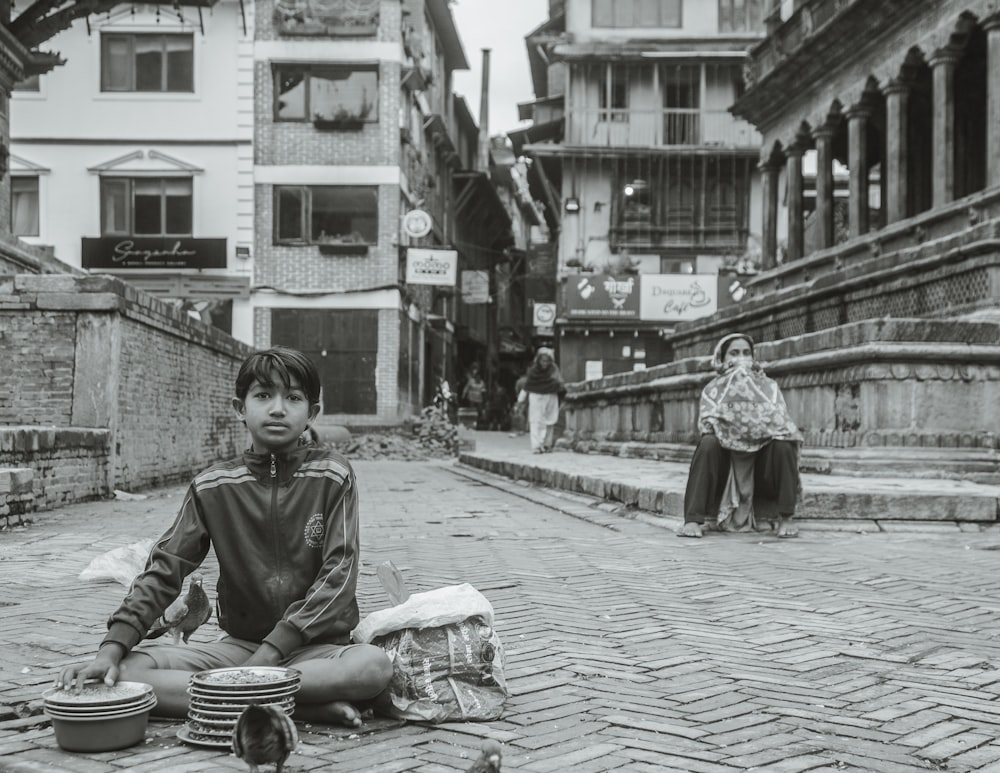 grayscale photo of girl sitting on floor