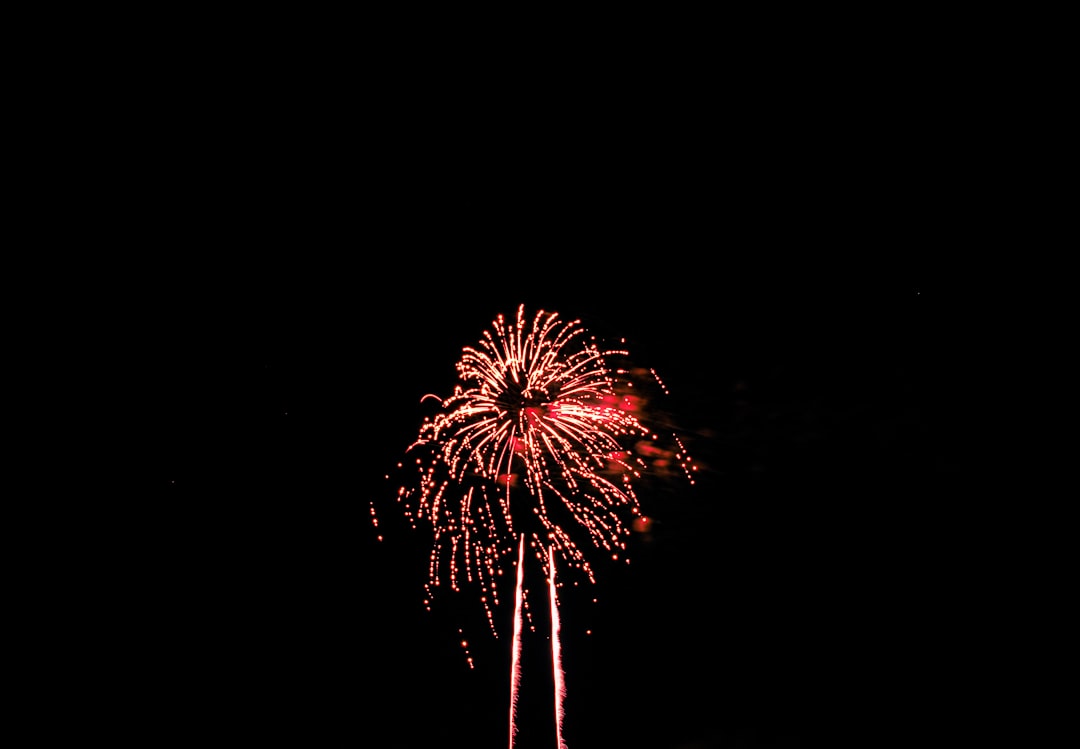 red and white fireworks in the sky,