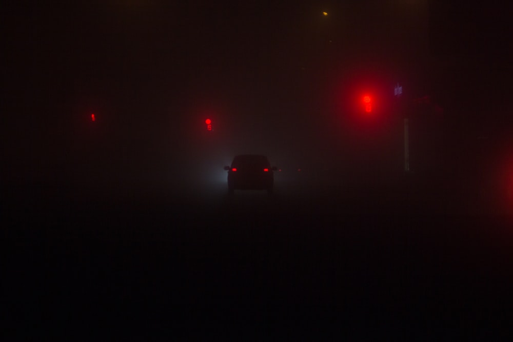 black car on road during night time