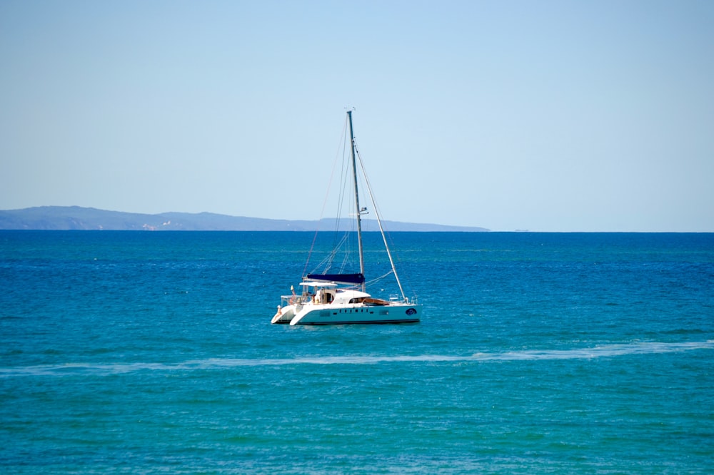 white and blue boat on sea during daytime