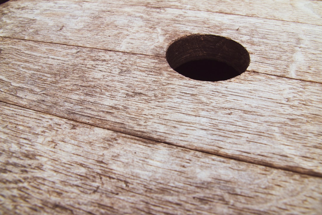 black round ornament on brown wooden surface