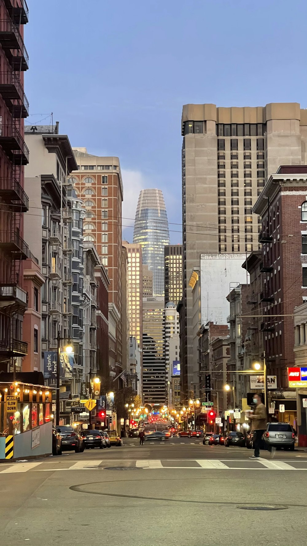 cars on road between high rise buildings during daytime