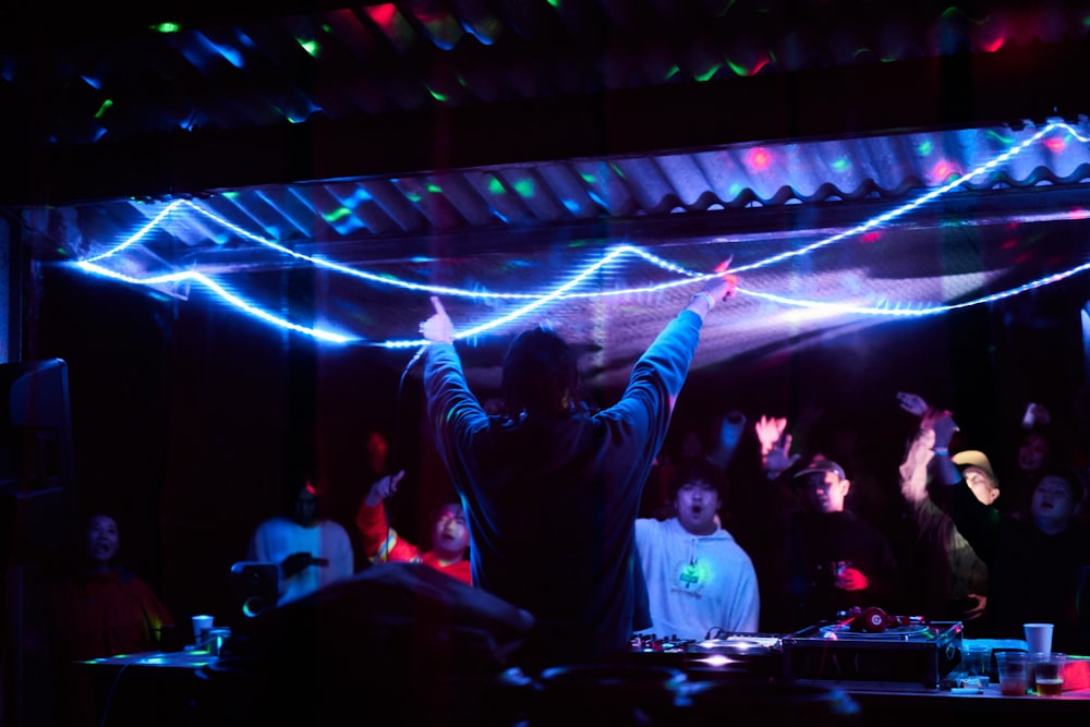 man in black long sleeve shirt standing on stage