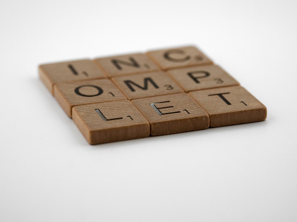 brown wooden letter blocks on white table