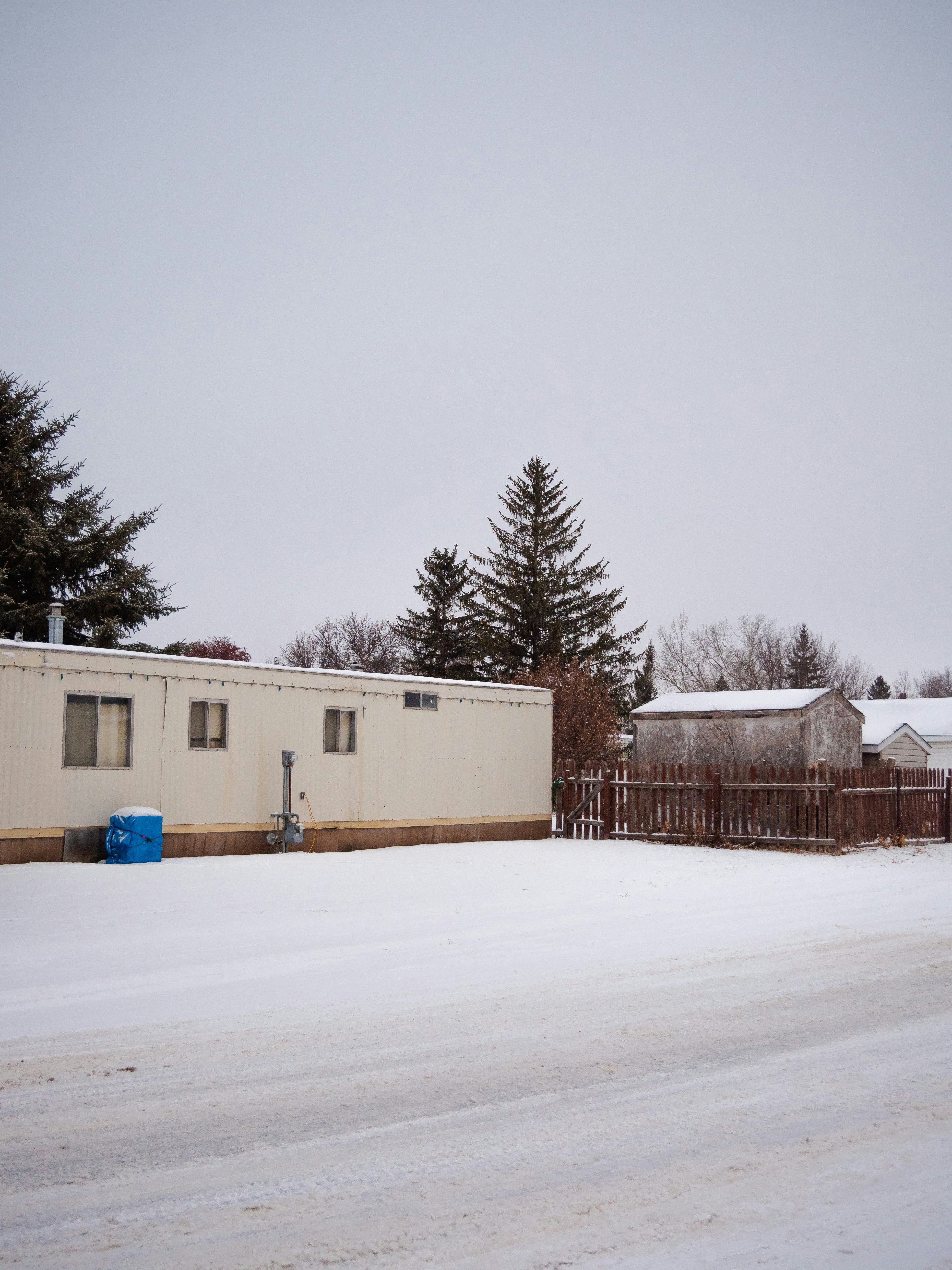 white and brown house on snow covered ground