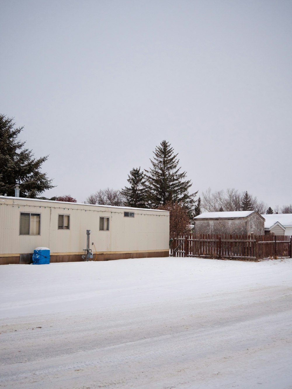 white and brown house on snow covered ground