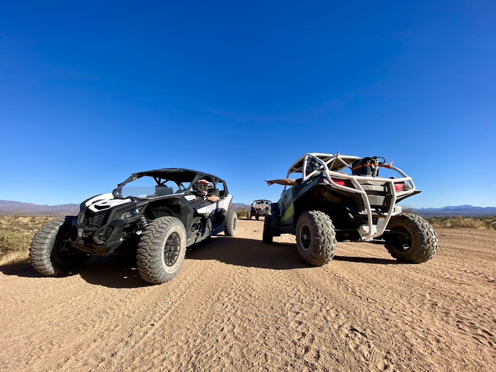 black and white jeep wrangler on brown sand during daytime