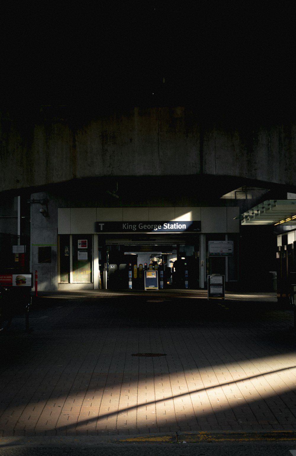 people walking on sidewalk during night time