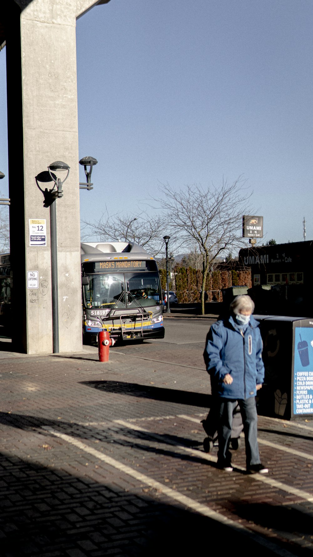 man in blue jacket standing beside woman in blue jacket