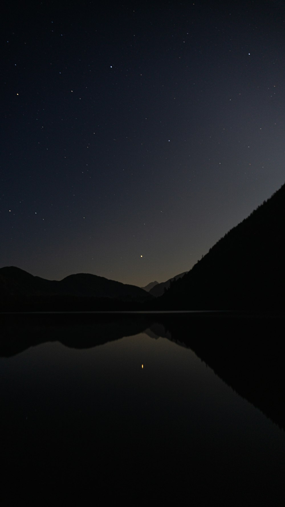 silhouette of mountains during night time