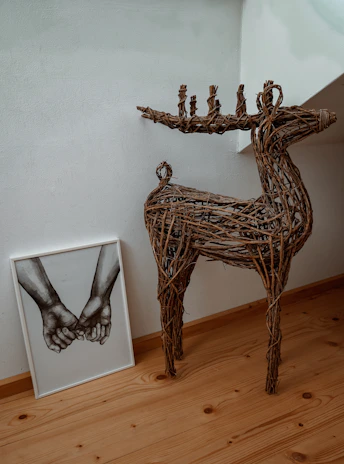 Art collector admiring a delicate pen and marker line drawing of a deer displayed in a modern gallery space.