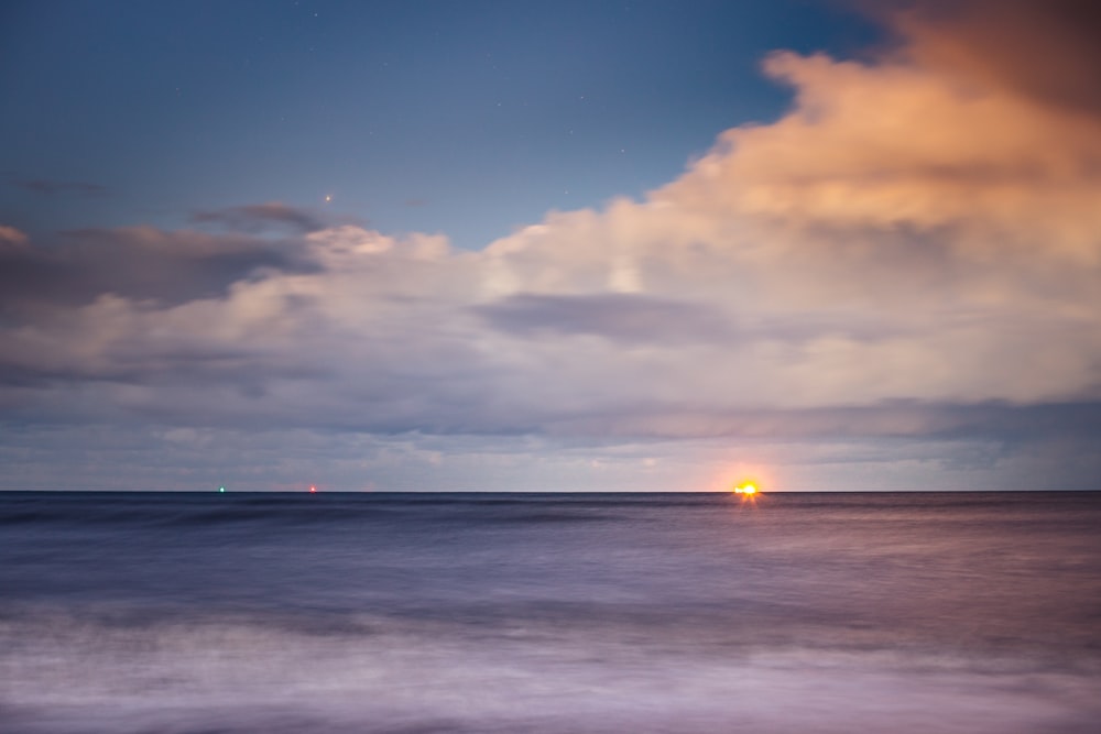 body of water under blue sky during sunset