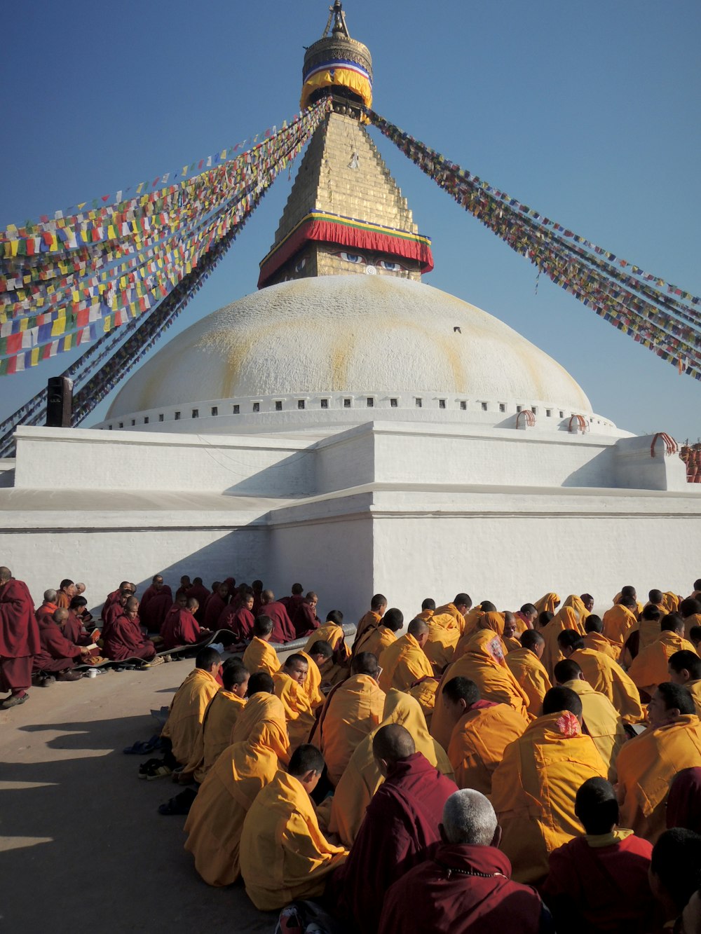 people in yellow uniform standing near white concrete building during daytime