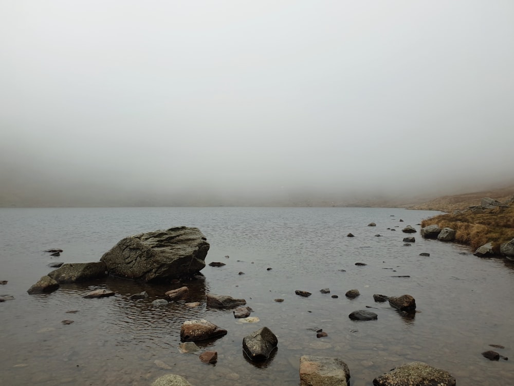 rocks on body of water during daytime