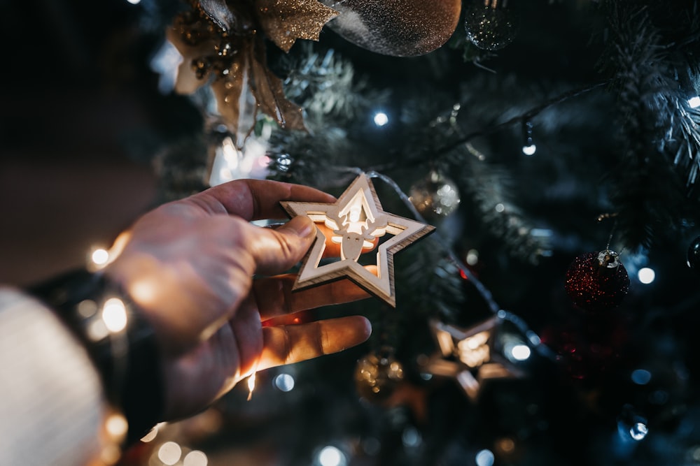 gold star ornament on persons hand